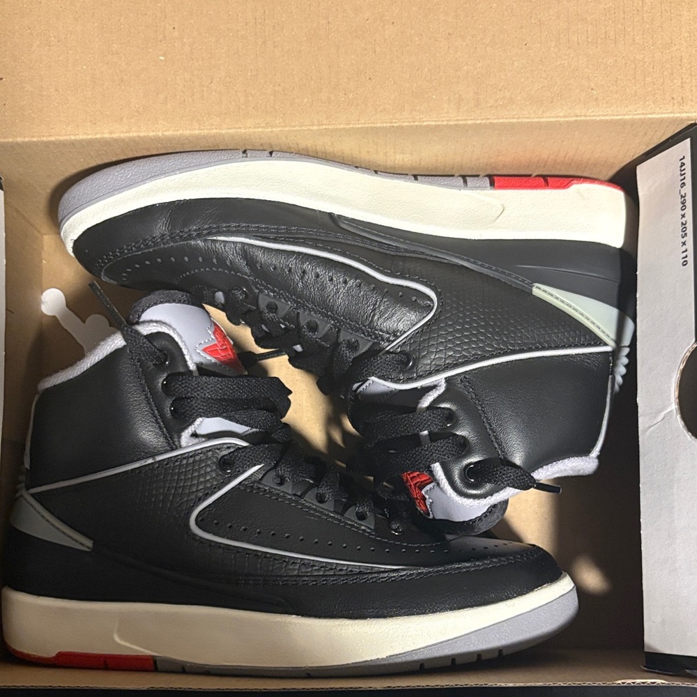Jordan Black and White High-Top Sneakers with Red Accents